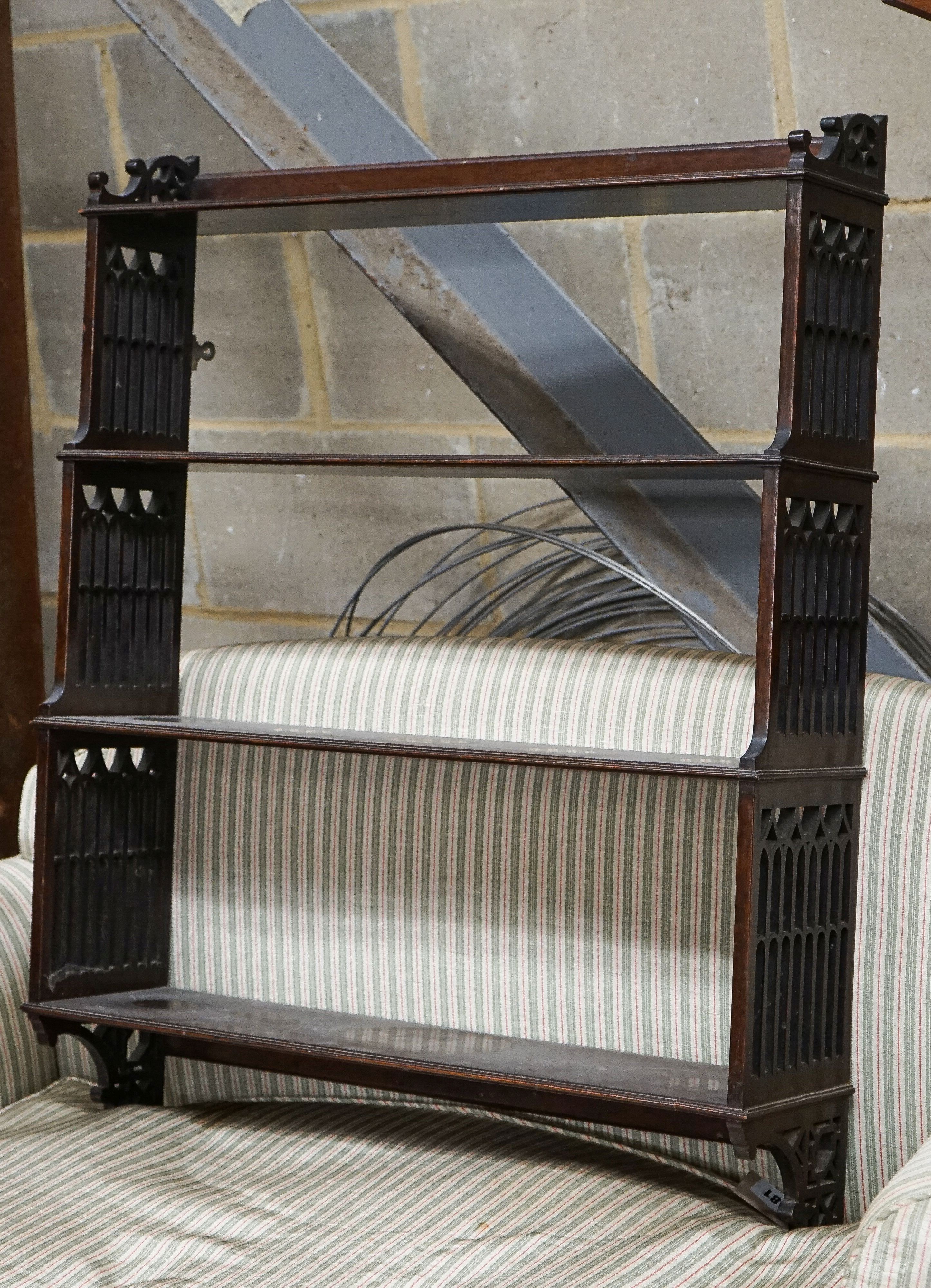 A George III style fret cut mahogany hanging four-tier wall shelf, width 70cm, depth 18cm, height 88cm